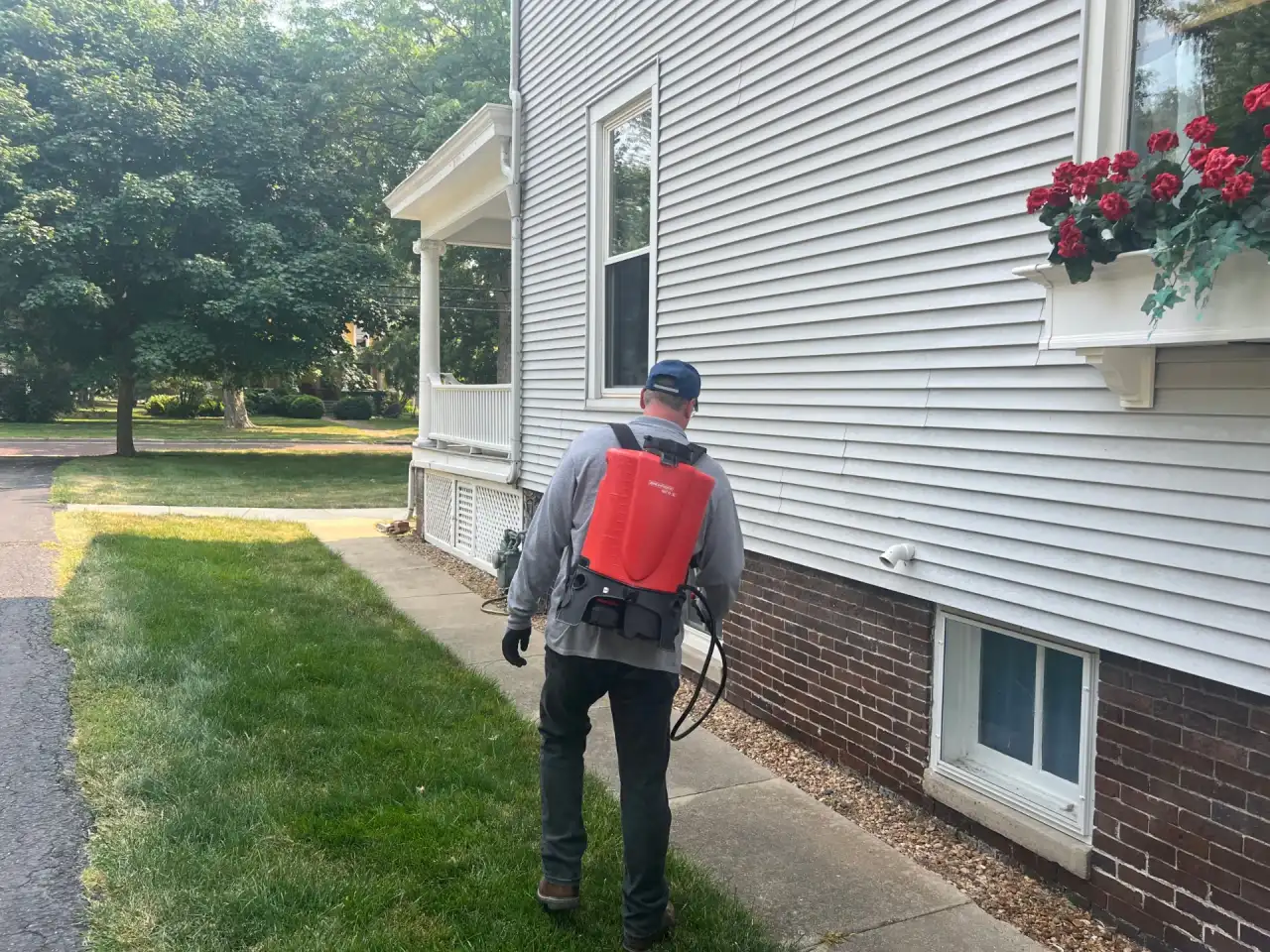 Technician applying a mosquito, flea and tick yard treatment